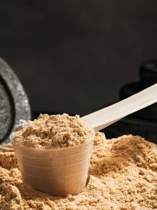 Protein Boost: Mixing Protein Powder with Yogurt.